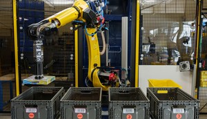 Amazon's robotic arm, Sparrow, lifts items in a fulfillment center.Amazon