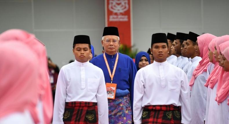 Malaysian Prime Minister Najib Razak (C) inspects a ceremonial guard of honour during the annual congress of his ruling party, the United Malays National Organisation (UMNO)