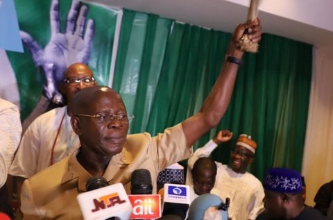 Oshiomhole waves the APC symbolic broom during a party meet (Punch)