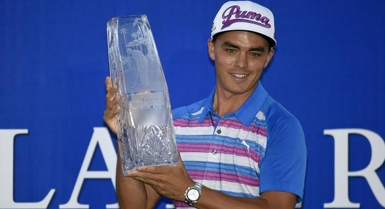 Ponte Vedra Beach, FL, USA; Rickie Fowler holds up The Players Championship trophy after winning the final round of The Players Championship at TPC Sawgrass - Stadium Course. Mandatory Credit: John David Mercer-USA TODAY Sports