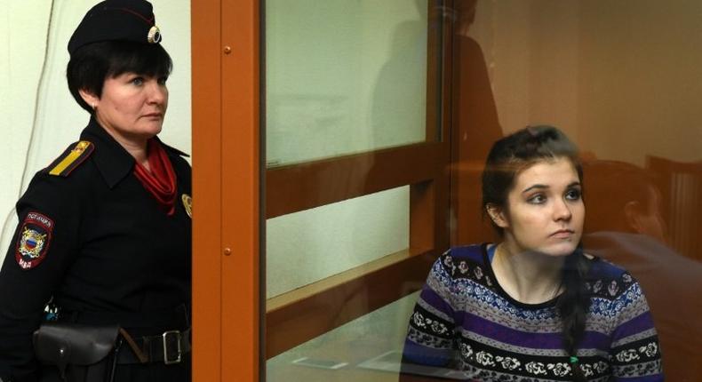 Moscow State University student Varvara Karaulova sits inside a defendants' cage during a hearing at the District Military Court on October 13, 2016