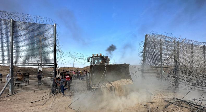 Palestinians break into the Israeli side of Israel-Gaza border fence after gunmen infiltrated areas of southern Israel.Mohammed Fayq Abu Mostafa/Reuters