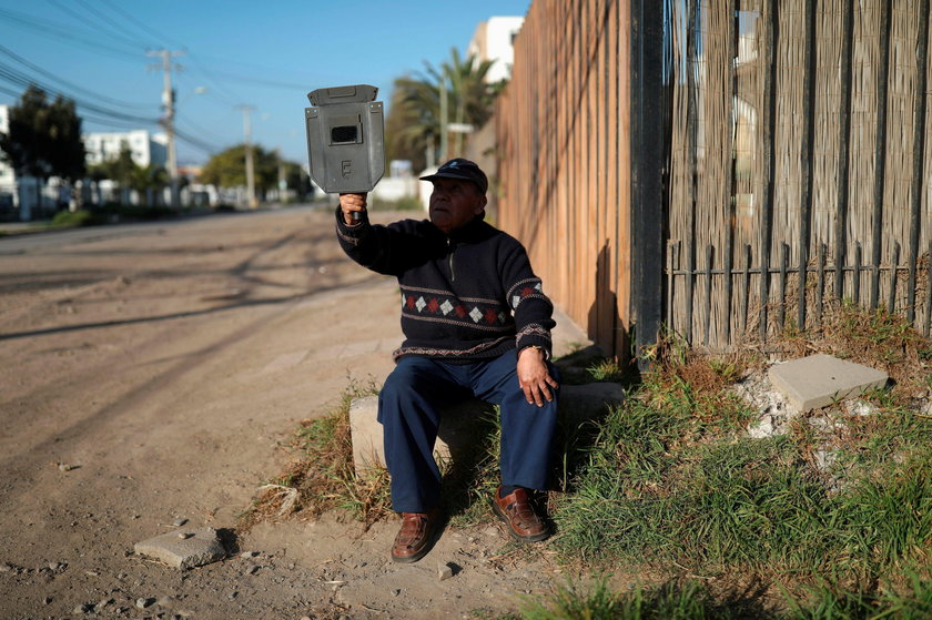 A mas wears a mask and a pair of eclipse glasses to observe a solar eclipse at La Serena