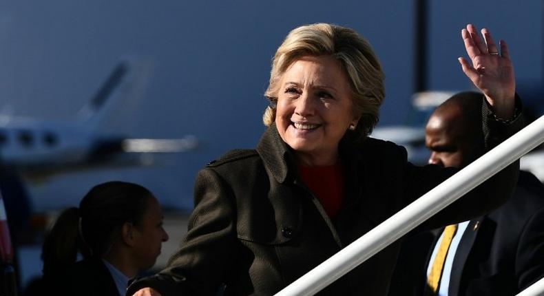 US Democratic presidential nominee Hillary Clinton waves as she boards her campaign plane at the Westchester County Airport in White Plains, New York, on October 31, 2016