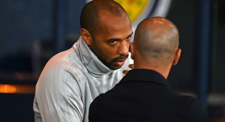 Thierry Henry speaks with Belgium coach Roberto Martinez