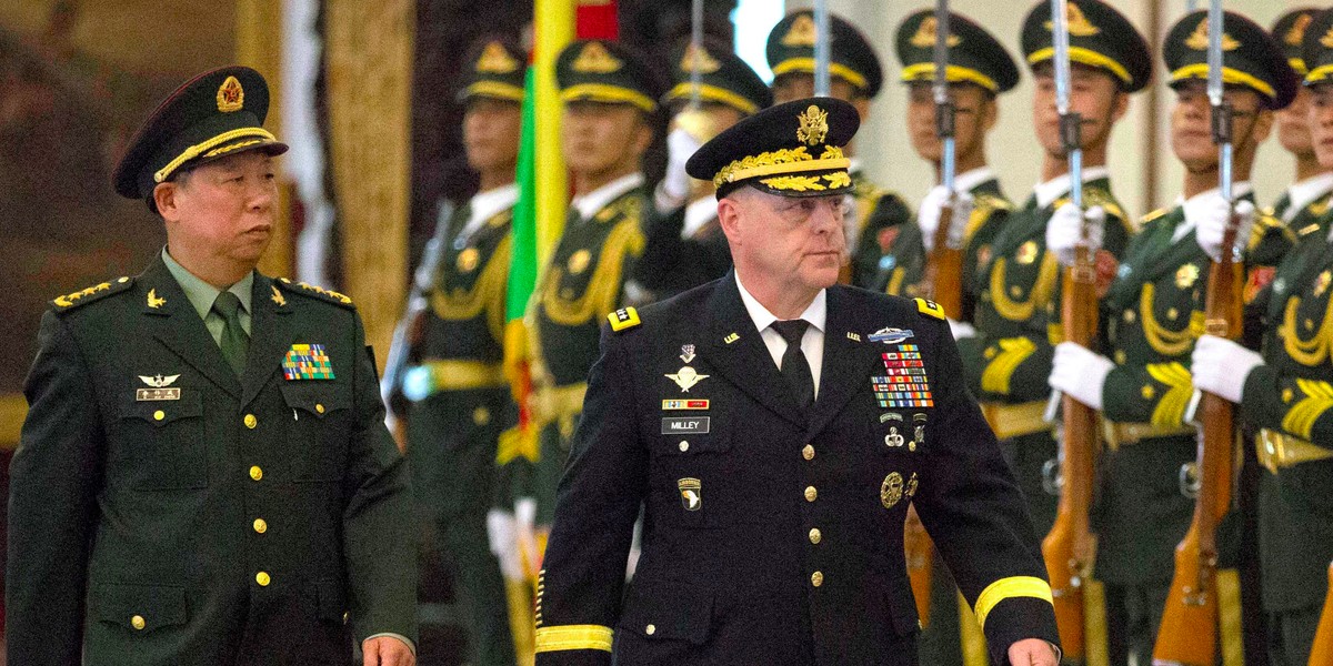 China's People's Liberation Army (PLA) Gen. Li Zuocheng, left, and US Army Chief of Staff Gen. Mark Milley, center, review an honor guard during a welcome ceremony at the Bayi Building in Beijing, Tuesday, Aug. 16, 2016.