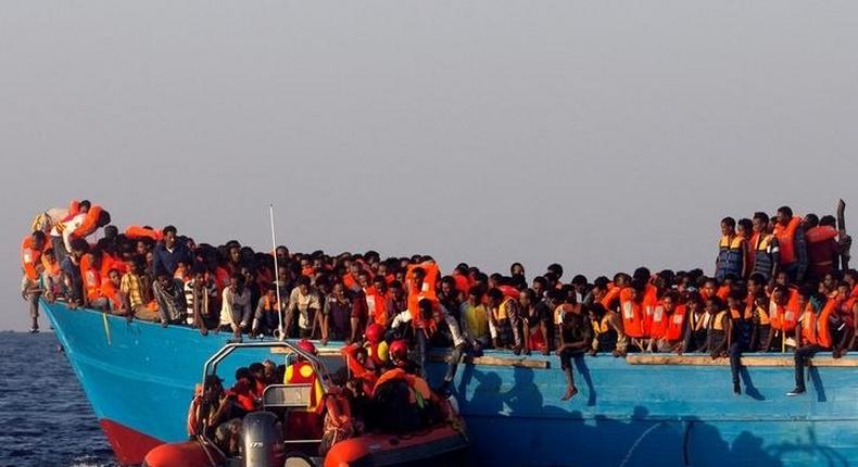 A rescue boat of the Spanish NGO Proactiva approaches an overcrowded wooden vessel with migrants from Eritrea, off the Libyan coast in Mediterranean Sea August 29, 2016. 