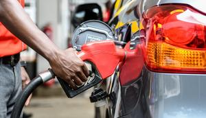 Attendant putting fuel in a car