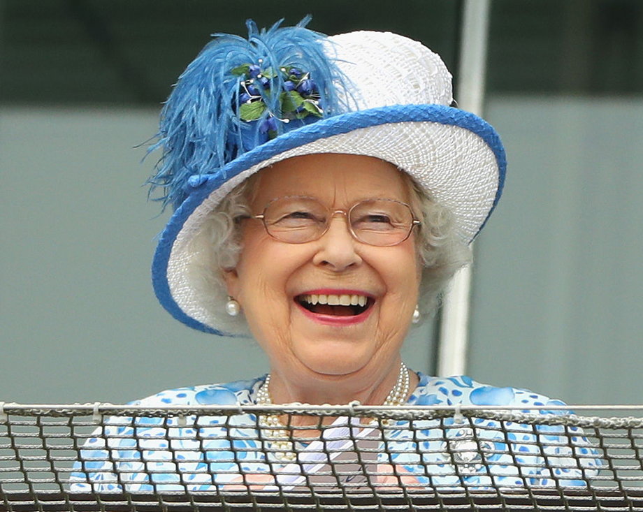Queen Elizabeth II laughs as she watches the racing at Epsom Racecourse on June 4, 2016 in Epsom, England.
