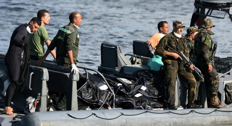 Egyptian medics arrive by boat with the bodies of migrants whose boat capsized in the Mediterranean, at the Egyptian port city of Rosetta