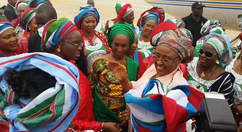 Wife of the President, Aisha Buhari (middle), wife of the Vice President, Dolapo Osinbajo (left) surrounded by women in Gombe state as the First Lady donated funds to bomb blast victims in the state.