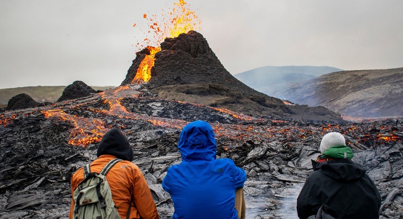 Hikers in an area where a volcano erupted in Iceland.
