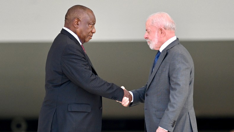 Brazil's President Luiz Inacio Lula da Silva (R) and South African President Cyril Ramaphosa shake hands during a welcome ceremony at the Planalto Palace in Brasilia, on March 9, 2026. [Photo by Evaristo Sa / AFP via Getty Images]