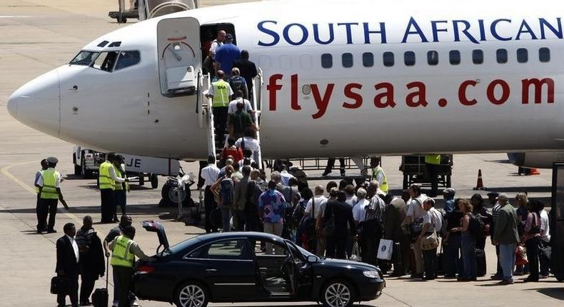 Passengers board a South African Airways Boeing 737 aircraft at the Kamuzu International Airport in Lilongwe, file. 