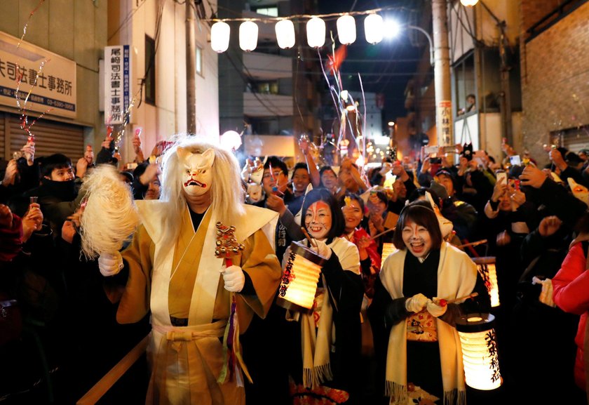 Participants dressed up as foxes attend the New Year's countdown event before they parade for the fi