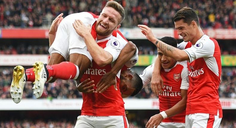 Theo Walcott (L) celebrates with teammates Shkodran Mustafi (2nd L), Alexis Sanchez (2nd R) and Granit Xhaka after scoring Arsenal's second goal against Swansea City