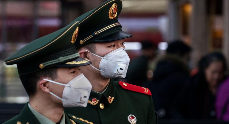 Chinese police officers wear protective masks at Beijing Station before the annual Spring Festival on January 22, 2020 in Beijing.Kevin Frayer/Getty Images