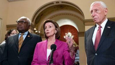 Speaker of the House Nancy Pelosi, D-Calif., accompanied by House Majority Whip James Clyburn, D-S.C., left and House Majority Leader Steny Hoyer D-MD, speaks to reporters at the Capitol in Washington, Friday, Nov. 5, 2021