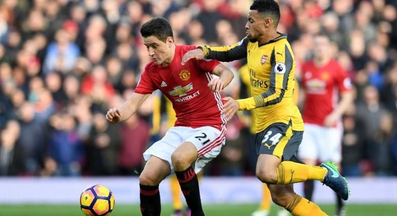 Manchester United's Spanish midfielder Ander Herrera (L) vies with Arsenal's French midfielder Francis Coquelin during the English Premier League football match between Manchester United and Arsenal on November 19, 2016