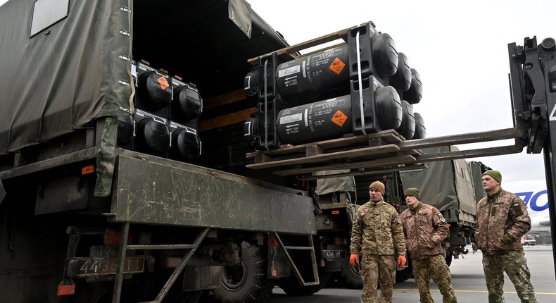 Ukrainian troops load a truck with US-made Javelins anti-tank missiles after their delivery at Kyiv's Boryspil airport on February 11, 2022.