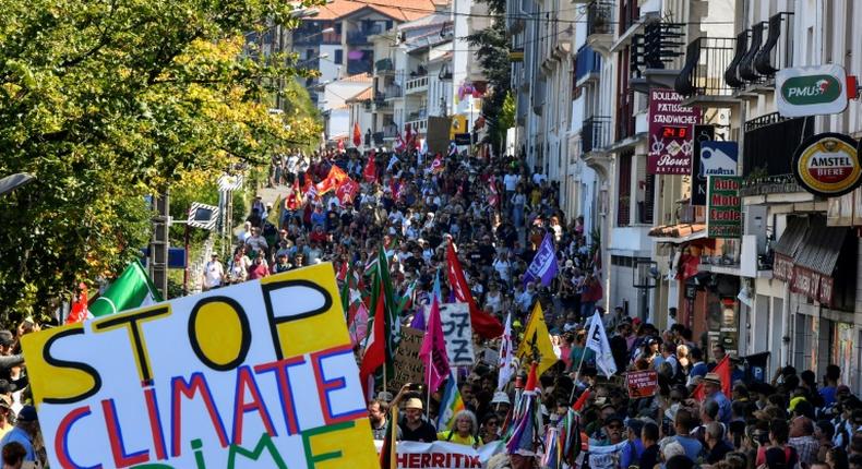 Demonstrators take part in a climate march in Hendaye, south-west France on August 24, 2019, to protest against the annual G7 Summit