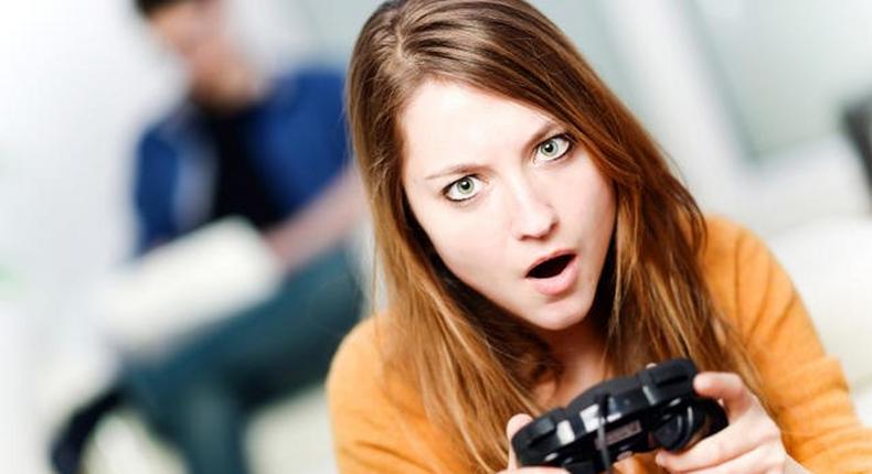 A young woman playing a video game.