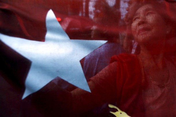 Supporters of Myanmar's pro-democracy figurehead Aung San Suu Kyi gather outside National League for