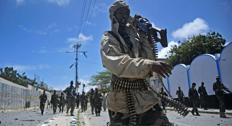 Somali security forces patrol the scene of a suicide car bomb blast in Mogadishu in August 2016