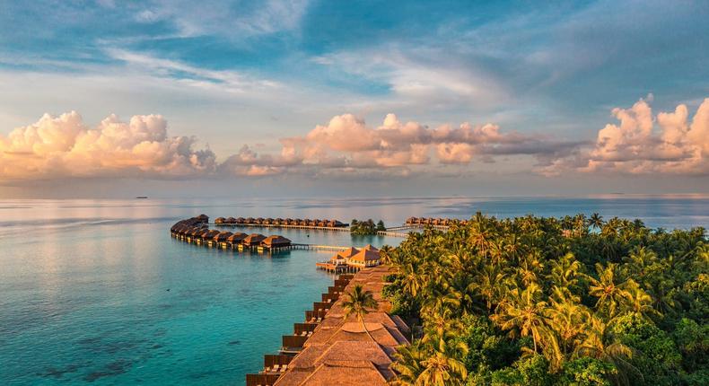 A row of overwater bungalows in the Maldivesgraphixel/Getty Images