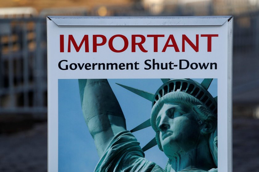 A sign announcing the closure of the Statue of Liberty, due to the U.S. government shutdown, sits ne