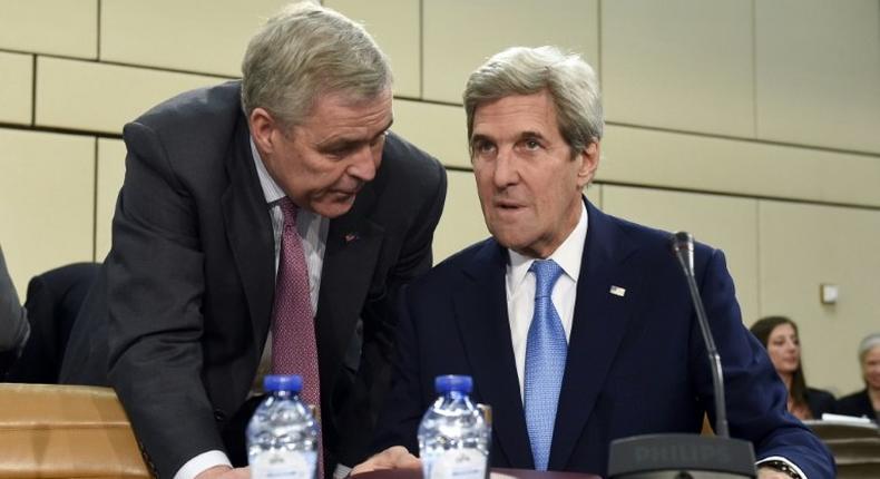 US Secretary of State John Kerry (R) listens to US ambassador to the NATO Douglas Lute during a meeting in Brussels on December 6, 2016