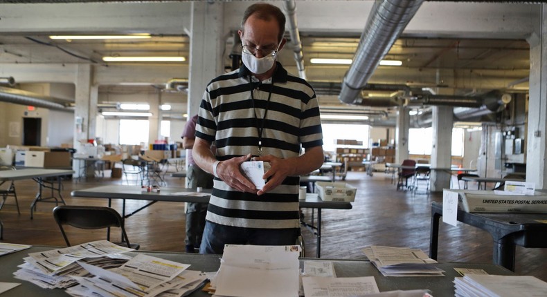 Mike Babinski opens applications for voter ballots at the Cuyahoga County Board of Elections Tuesday, July 14, 2020, in Cleveland