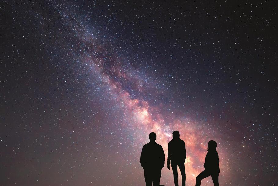 Milky Way. Night sky and silhouette of a family