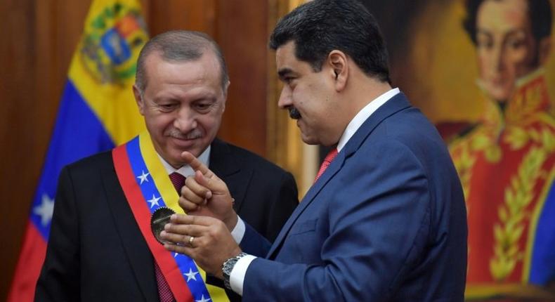 Venezuelan President Nicolas Maduro decorates Turkish President Recep Tayyip Erdogan with the Order of the Liberator in Caracas