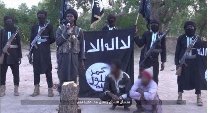 Screen shot from Boko Haram video showing amputation of two men's hands