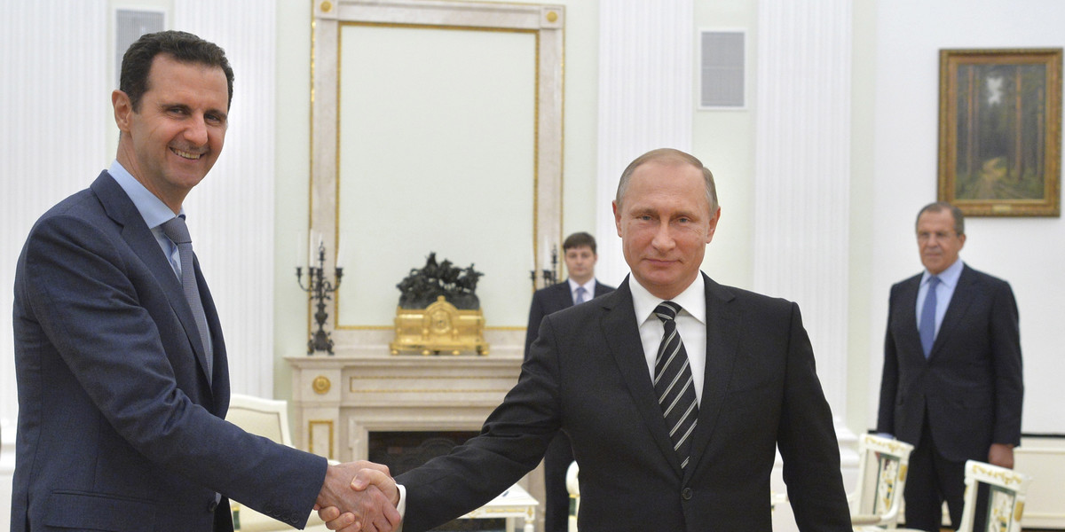 Russian President Vladimir Putin (R) shakes hands with Syrian President Bashar al-Assad during a meeting at the Kremlin in Moscow, Russia, October 20, 2015.