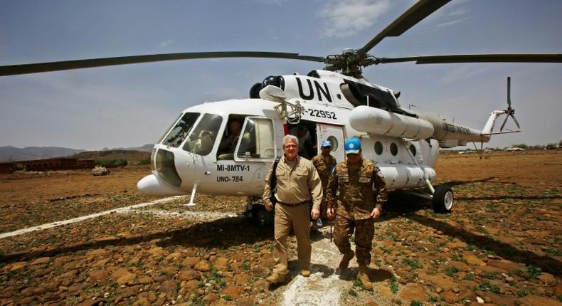 US envoy to Sudan Steven Koutsis (L) disembarks from a UN helicopter after landing in the war-torn town of Golo in the Jebel Marra region of central Darfur on June 19, 2017