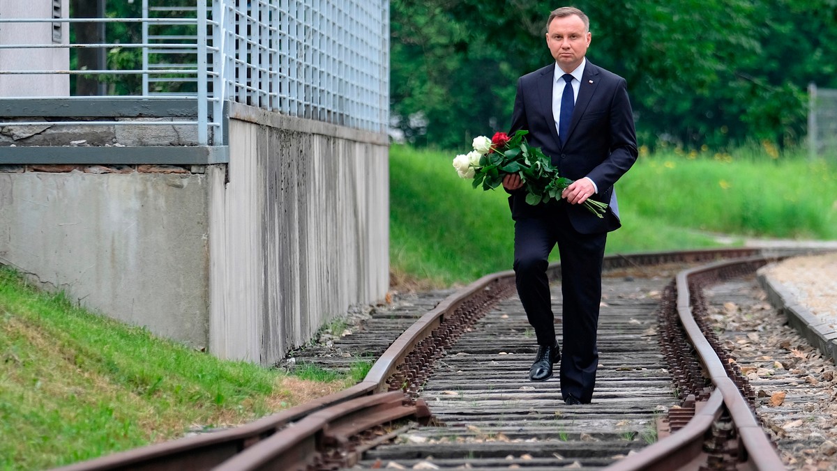 Andrzej Duda składa kwiaty na torach Małopolskiej Uczelni Państwowej w Oświęcimiu, którymi przewożono więźniów obozu