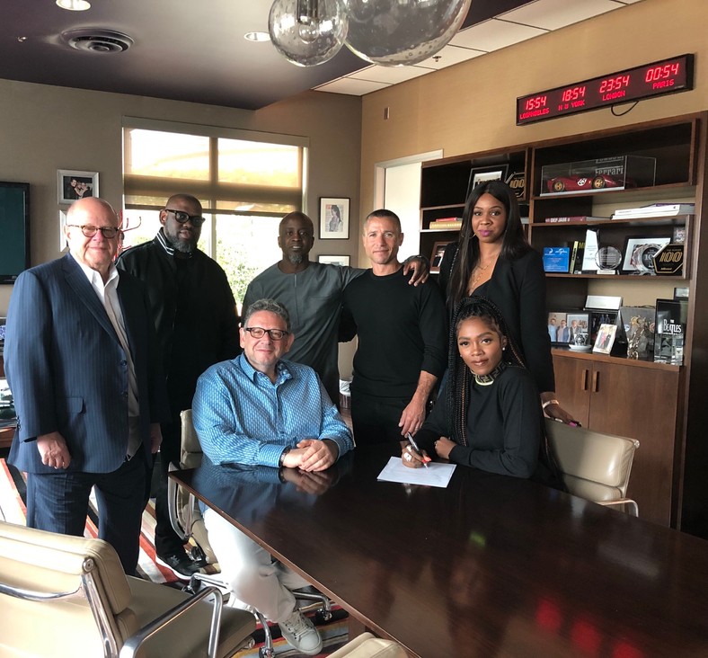 Tiwa Savage signing her record deal with Universal Music Group. (UMG) [Ashley Eberbach] 