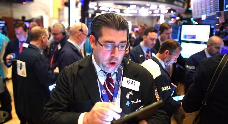 Traders work during the opening bell at the New York Stock Exchange (NYSE)