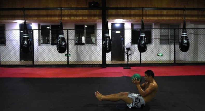 Chinese mixed martial arts (MMA) fighter Li Jingliang trains at a gym in Beijing