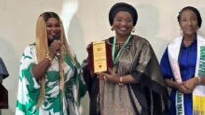 Hajiya Neemat Abdulrahim, Director, FCT Education Resource Centre, receiving her award. (Credit: NAN)
