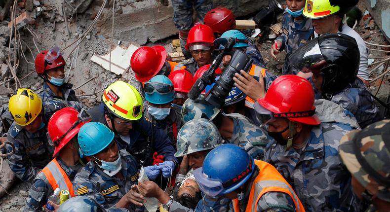 A teenager is carried on a stretcher after being rescued by Nepalese policemen and U.S. rescue workers from a building that collapsed five days after the devastating Earthquake.