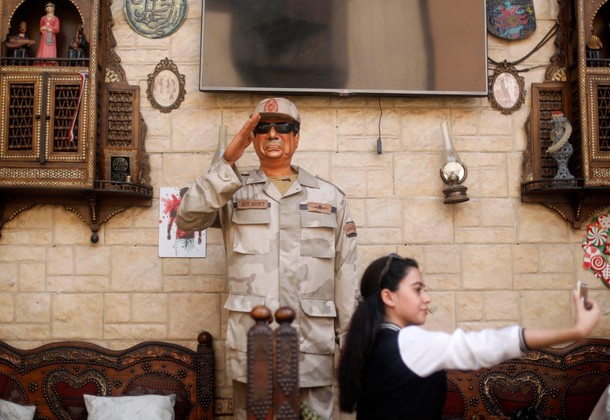 Woman takes a selfie with an effigy depicting Egyptian President Abdel Fattah al-Sisi during the sec