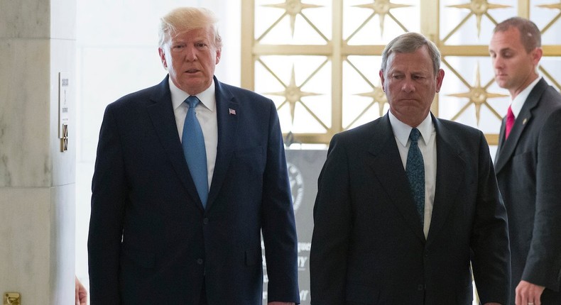 President Donald Trump, left, walks with Supreme Court Chief Justice John Roberts as he arrives to view the casket of Justice John Paul Stevens at the Supreme Court, Monday, July 22, 2019.