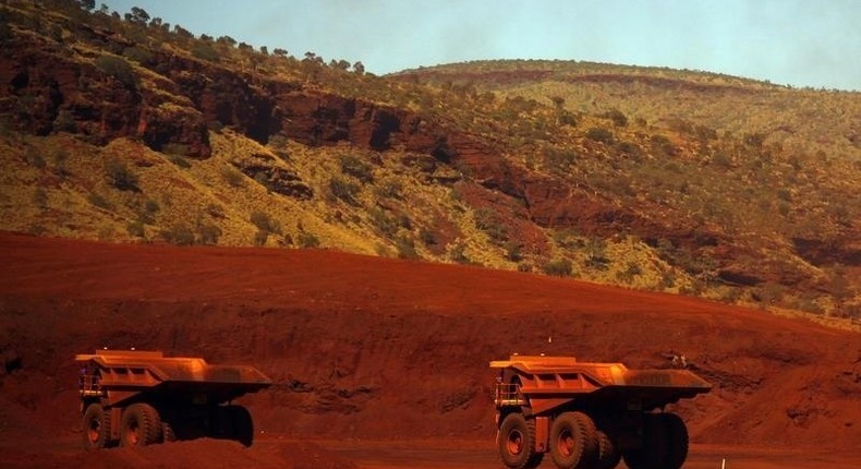 Trucks wait to be loaded with iron ore at the Fortescue Solomon iron ore mine located in the Valley of the Kings, around 400 km (248 miles) south of Port Hedland in the Pilbara region of Western Australia, in a file photo. REUTERS/David Gray