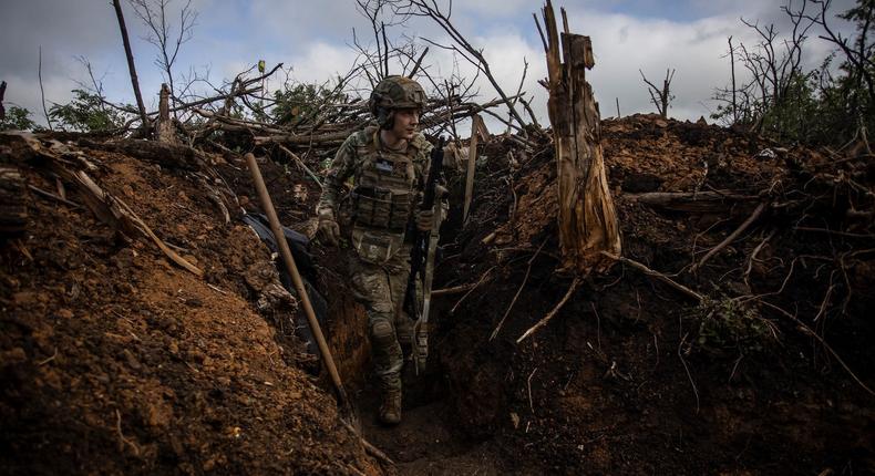 A Ukrainian serviceman walks in a trench at a position near the frontline town of Bakhmut, Ukraine, on May 30 2023REUTERS/Yevhenii Zavhorodnii