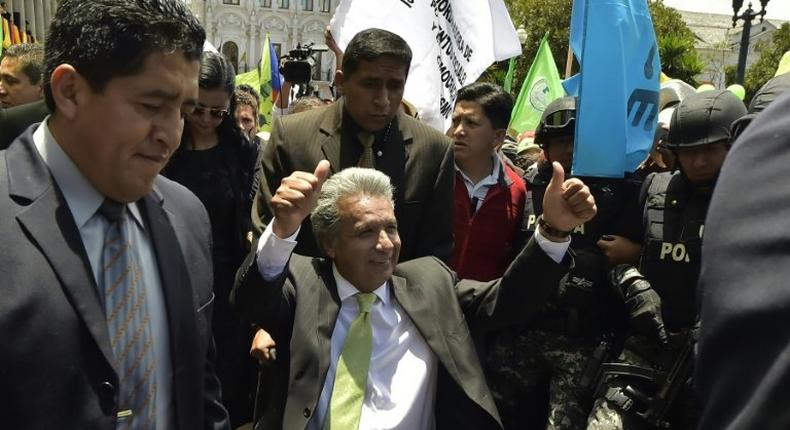 Ecuador's President-elect Lenin Moreno (C) greets supporters at the Plaza Grande in Quito on April 3, 2017