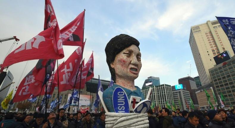 South Korean protesters carry an effigy of President Park Geun-Hye during an anti-government rally in Seoul, on November 30, 2016