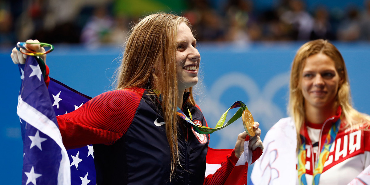 Lilly King accepts her gold medal in the 100-meter breaststroke with silver medalist Yulia Efimova.